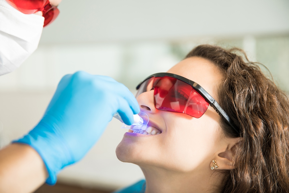 closeup-young-woman-having-her-teeth-whitened-with-ultraviolet-light-dental-clinic.jpg